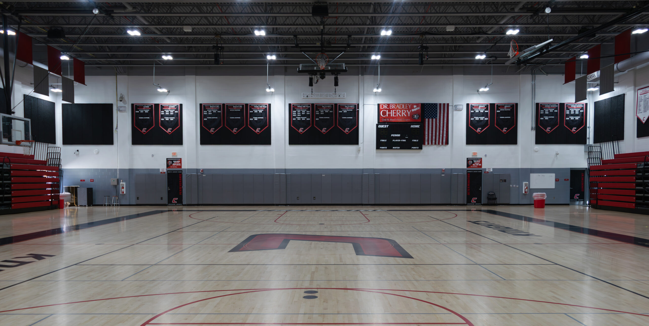 After: Fully equipped Portable Church worship setup inside a gymnasium with lighting, stage, and audience seating.